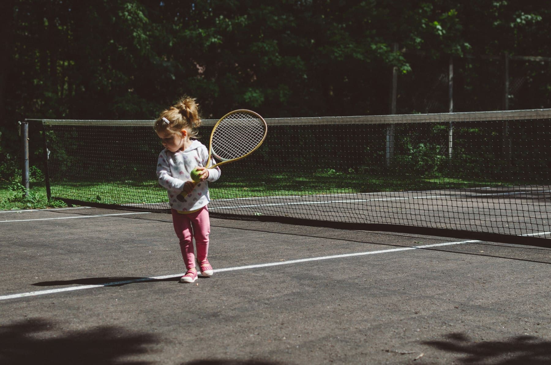 A young girl with her racquet at the net